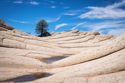 Low angle view of rock formation against sky