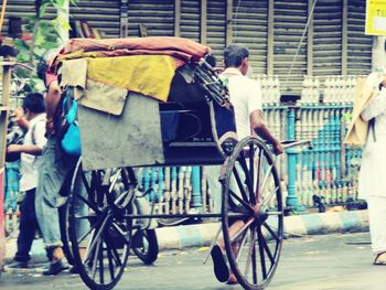 Rear view of people working on street