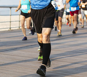 Low section of man running on floor