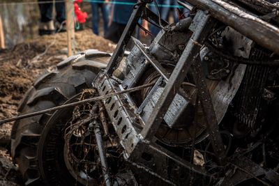 Close-up of abandoned vintage car on field