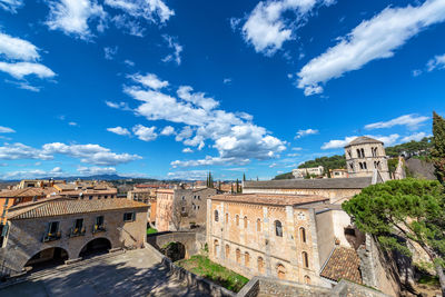 Buildings in city against blue sky