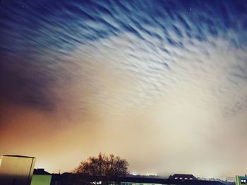 Low angle view of silhouette trees against sky