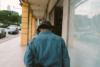 Rear view of man on street in city