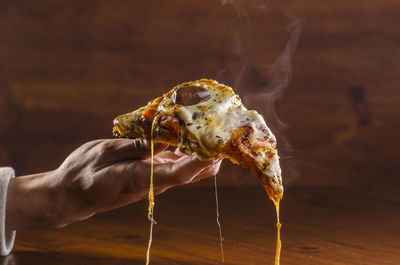 Cropped hand of man holding fish