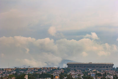 High angle view of buildings against cloudy sky