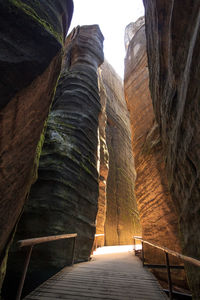 Narrow walkway leading towards mountain