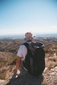 Man looking at mountain against sky