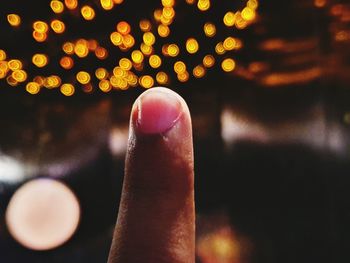 Close-up of hand holding illuminated light painting at night