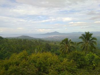 Scenic view of mountains against cloudy sky