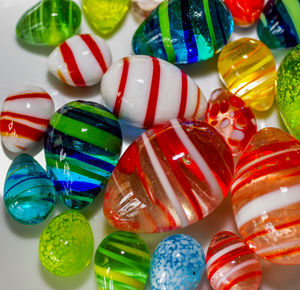 Close-up of colorful marble balls and pebbles on table