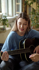 Young woman playing guitar