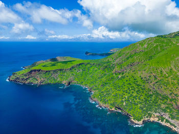 High angle view of sea and mountains against sky