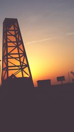 Low angle view of built structure against sky at sunset