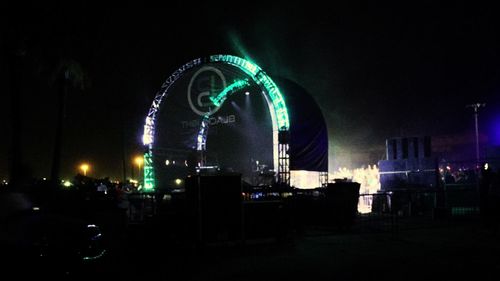 Illuminated ferris wheel at night