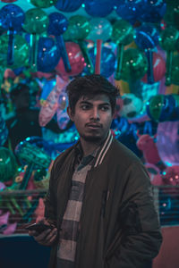 Man standing against toys at market