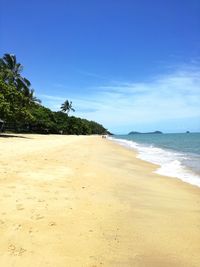 Scenic view of beach against blue sky