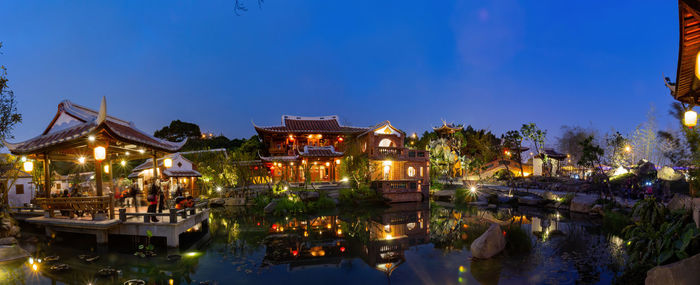 Panoramic view of illuminated buildings against sky at night