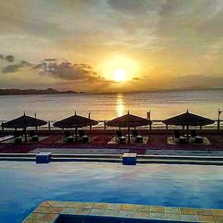 View of swimming pool at beach during sunset