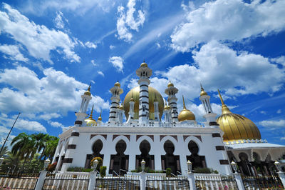 Low angle view of building against cloudy sky