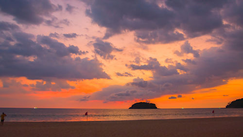 Scenic view of beach against sky during sunset