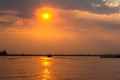 Scenic view of sea against orange sky