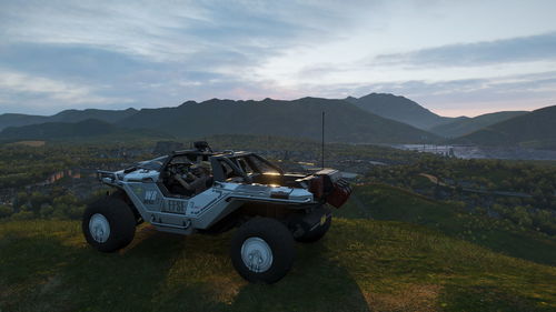 Vintage car on field against mountains