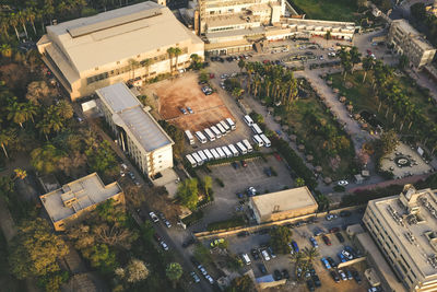 Aerial view of buses and cars parked at parking lot in city