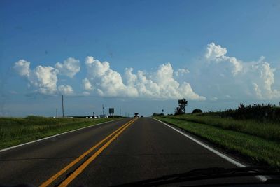 Road against sky seen through car windshield