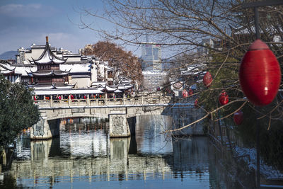 View of built structure with bare trees in water