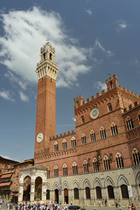 Low angle view of clock tower against sky