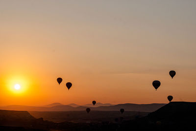 Hot air balloons in sky during sunset