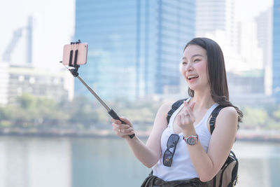 Portrait of smiling woman photographing