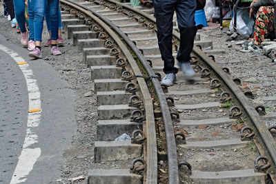 High angle view of people walking on railroad track