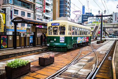 Railroad tracks amidst buildings in city