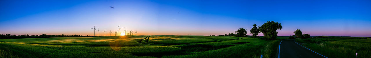 Panoramic view of field against sky during sunset