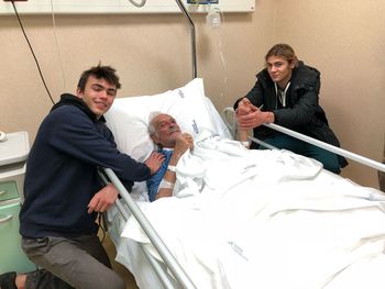 Friends with senior patient in hospital