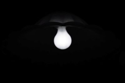 Close-up of illuminated lamp against black background