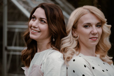 Two mature sisters in the garden in the evening. portrait of woman at her 40s and 30s, relatives