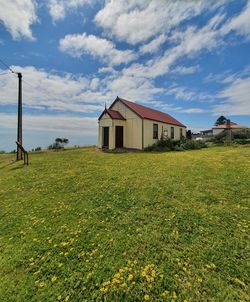 House on field against sky