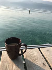 High angle view of coffee on table by sea