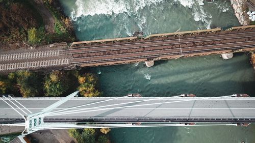 High angle view of bridge over road against trees