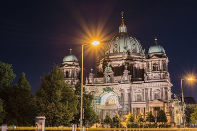 Illuminated cathedral against sky at night