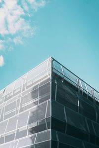 Low angle view of modern building against blue sky