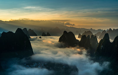 Scenic view of silhouette mountains against sky during sunset