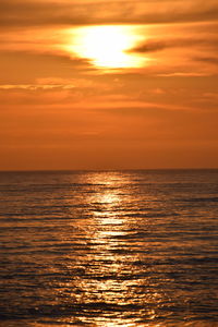 Scenic view of sea against orange sky