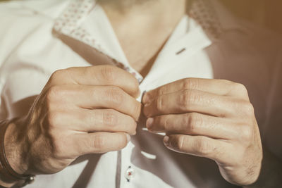 Midsection of man wearing shirt