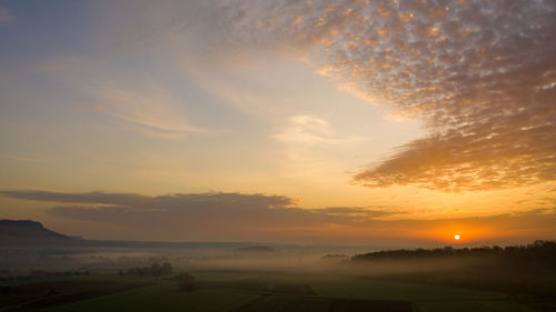 Scenic view of sunset over land