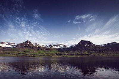 Scenic view of lake and mountains against sky