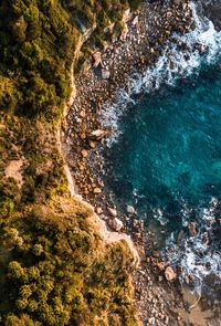 High angle view of rocks on sea shore