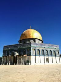 Low angle view of built structure against blue sky